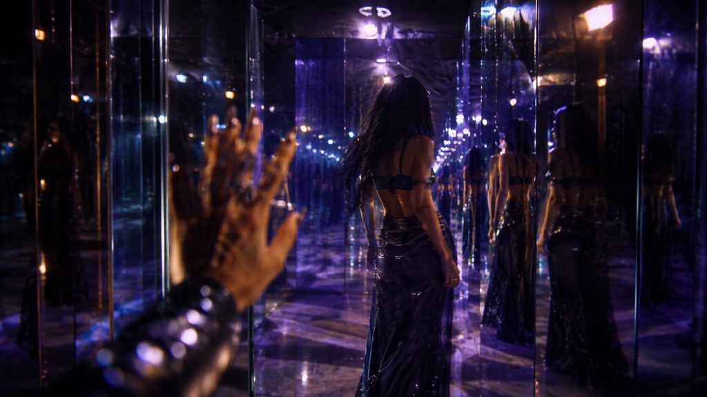 A mirrored hallway with repeating reflections symbolizing obsession and the unforgettable chorus of “She Did It Again” by Tyla and Zara Larsson.